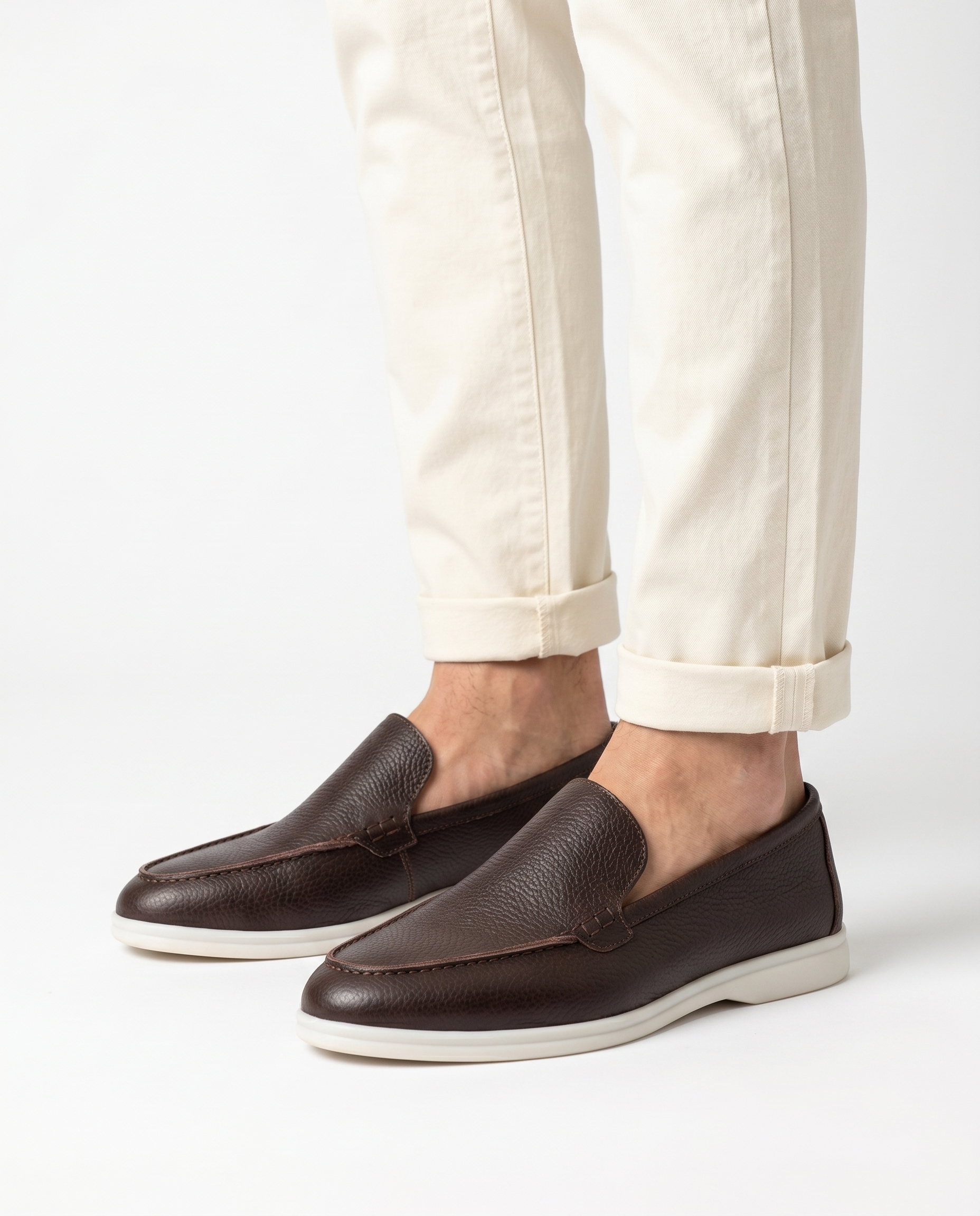 Brown Kashmir leather loafer worn by model on white background