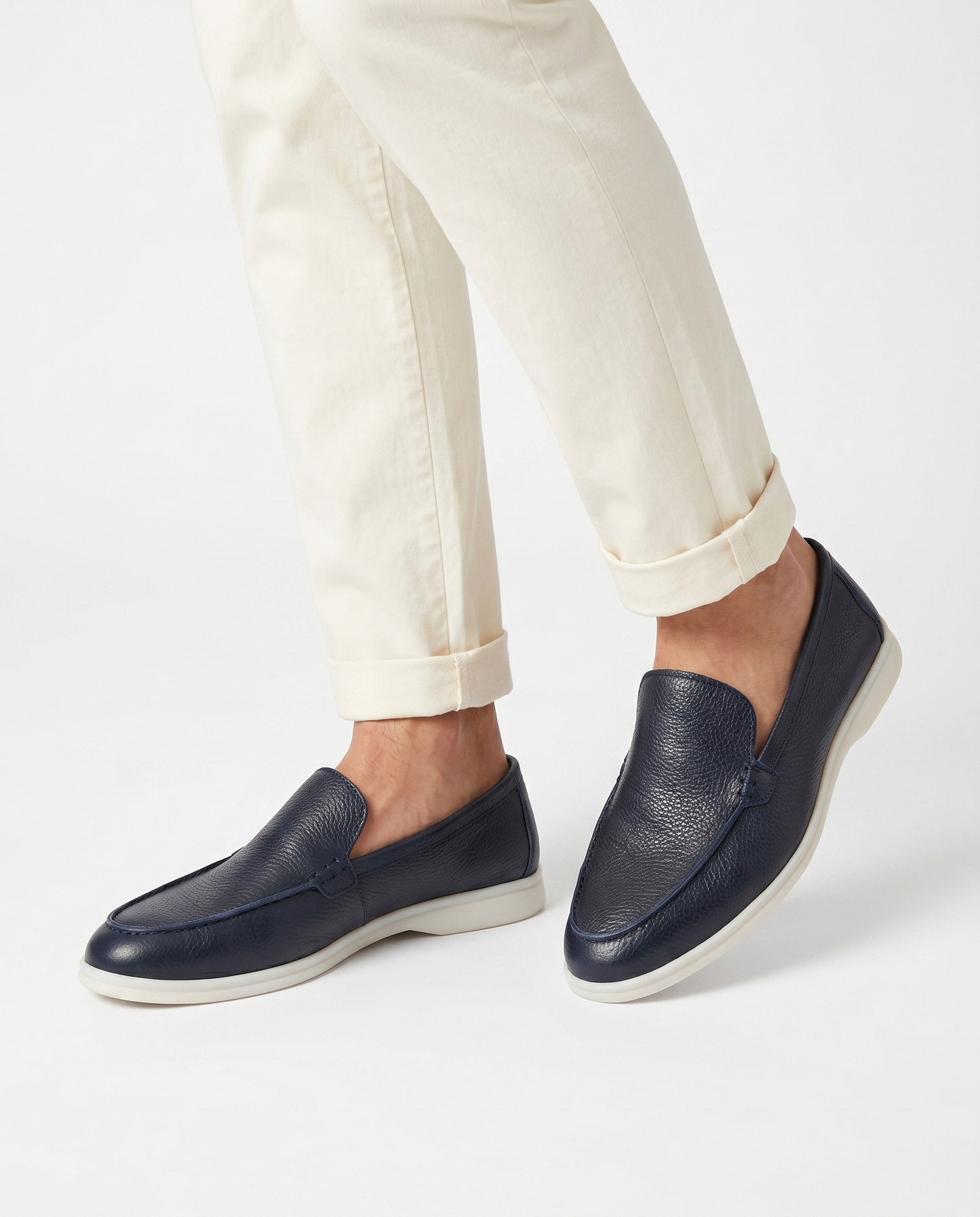 Navy Kashmir leather loafer worn by model on white background