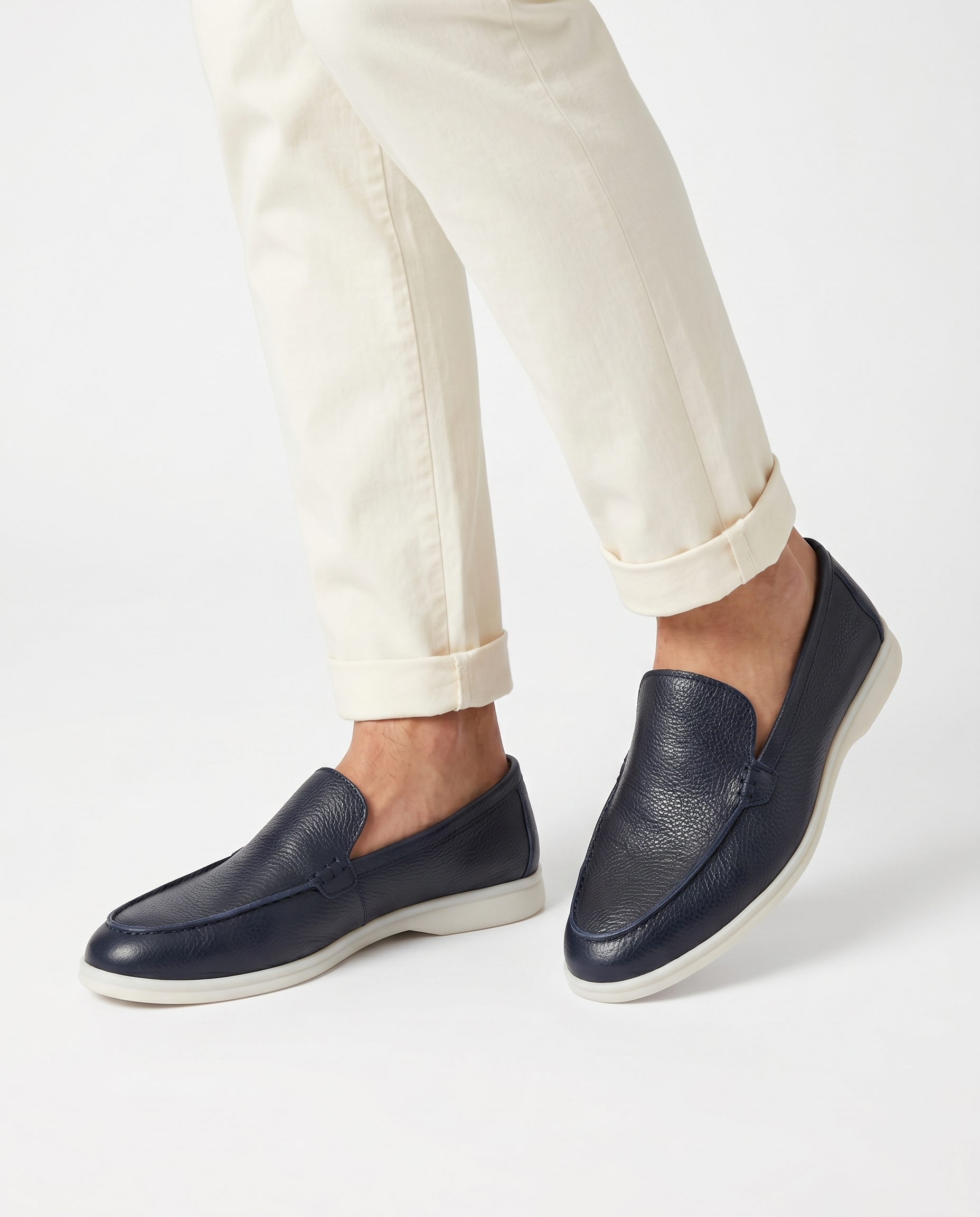 Navy Kashmir leather loafer worn by model on white background